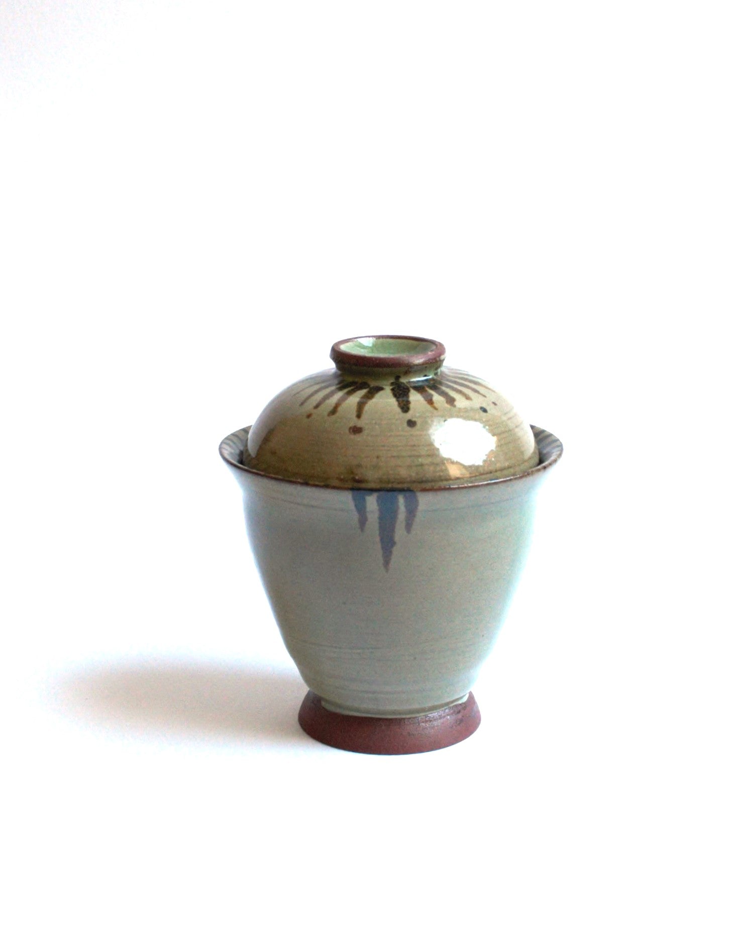 Lidded bowl in wam green with iron strokes