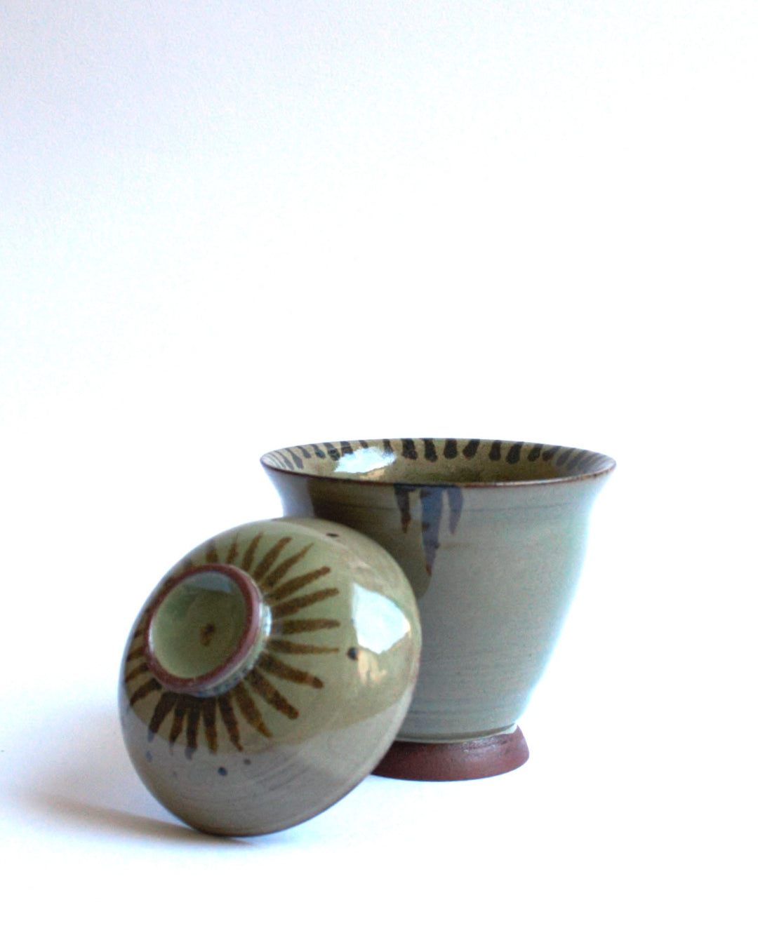 Lidded bowl in wam green with iron strokes
