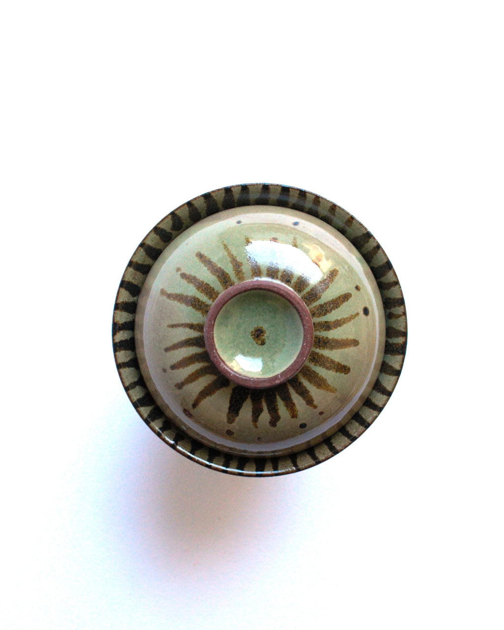 Lidded bowl in wam green with iron strokes
