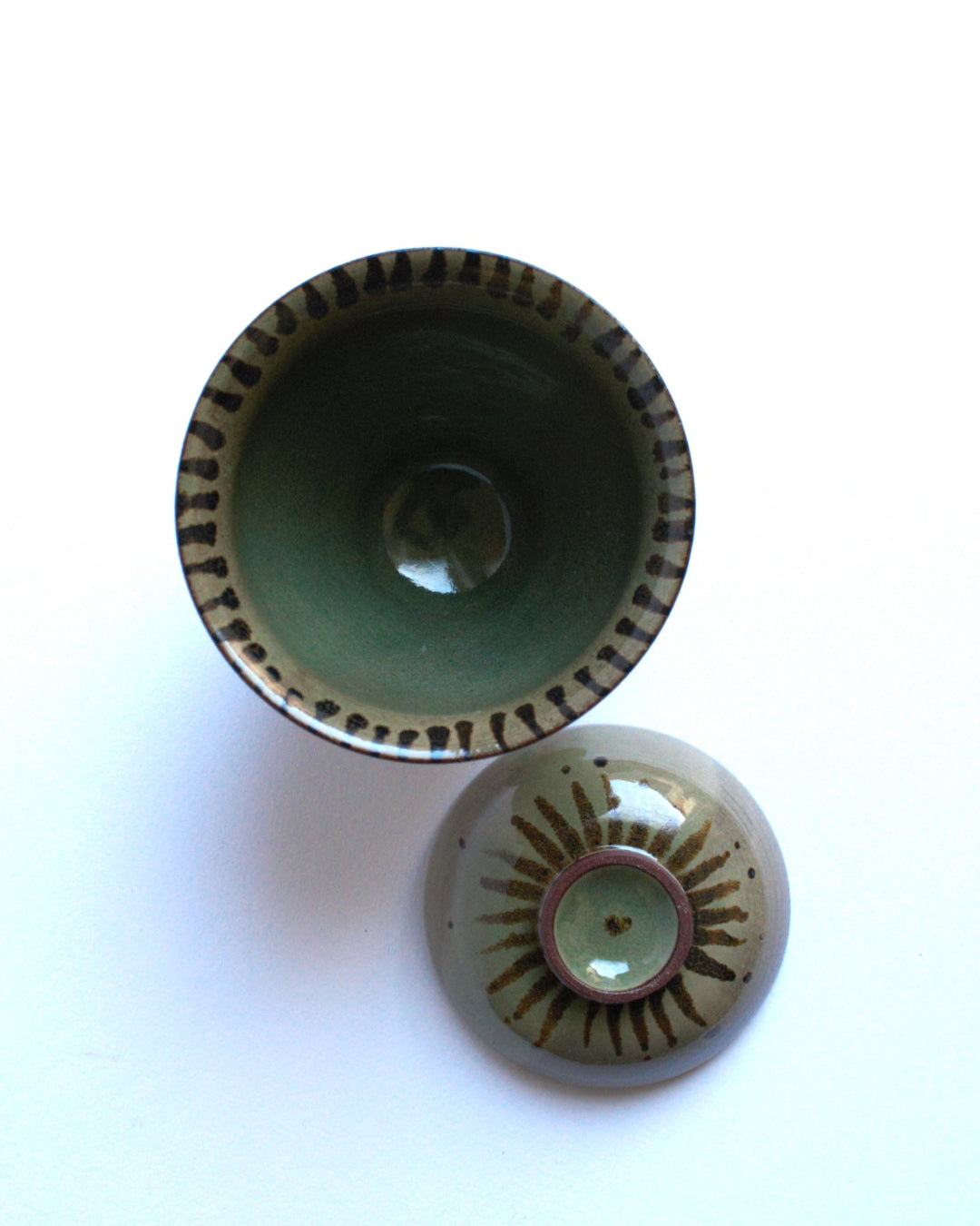 Lidded bowl in wam green with iron strokes