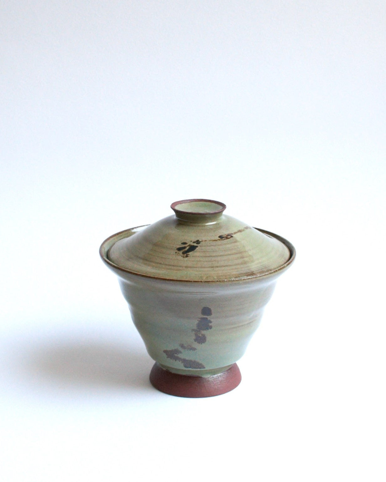 Ceramic bowl with lid on a white background