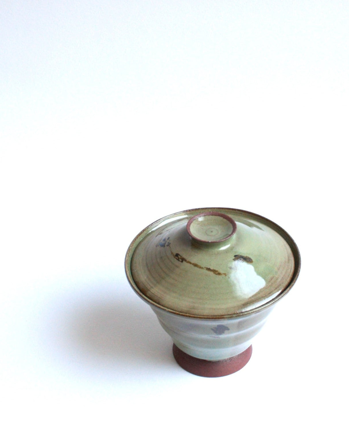 Ceramic bowl with lid on a white background