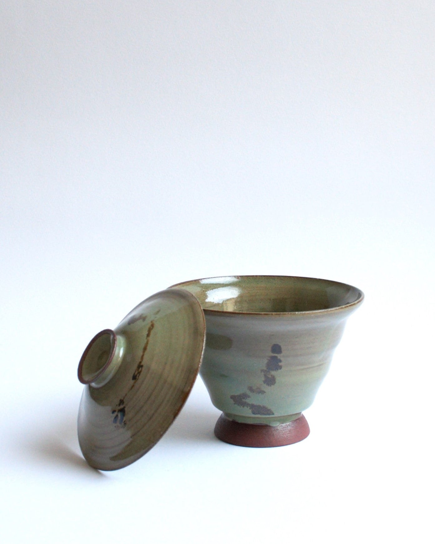 Ceramic bowl with lid on a white background