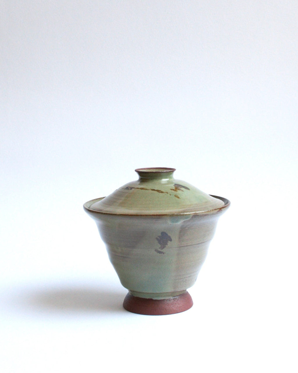 Ceramic jar with lid on a white background