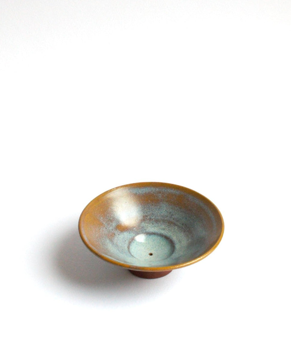 Small ceramic bowl with a glossy finish on a white background