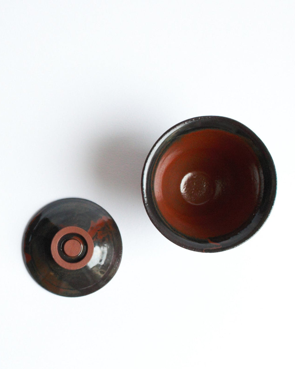 Ceramic lid and bowl on a white background