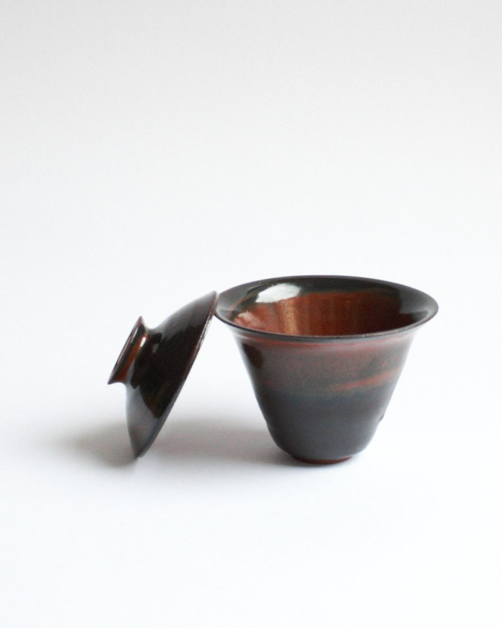 Ceramic teapot with lid on a white background