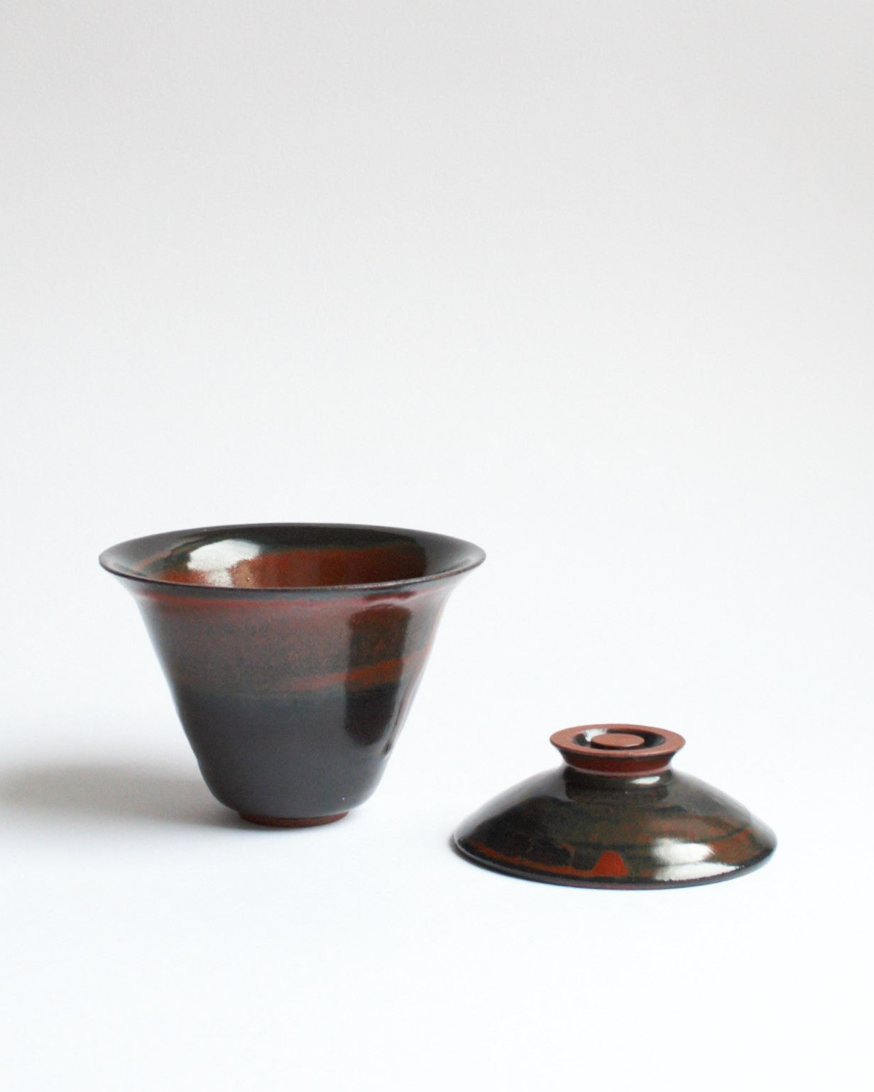 Ceramic cup with lid on a white background
